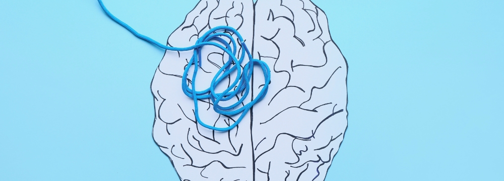 drawing of a brain with blue yarn tangled inside